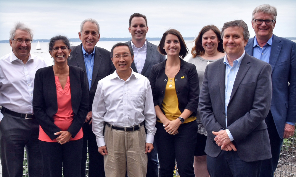 A group of SPIE committee members gather for a photo overlooking Bellingham Bay