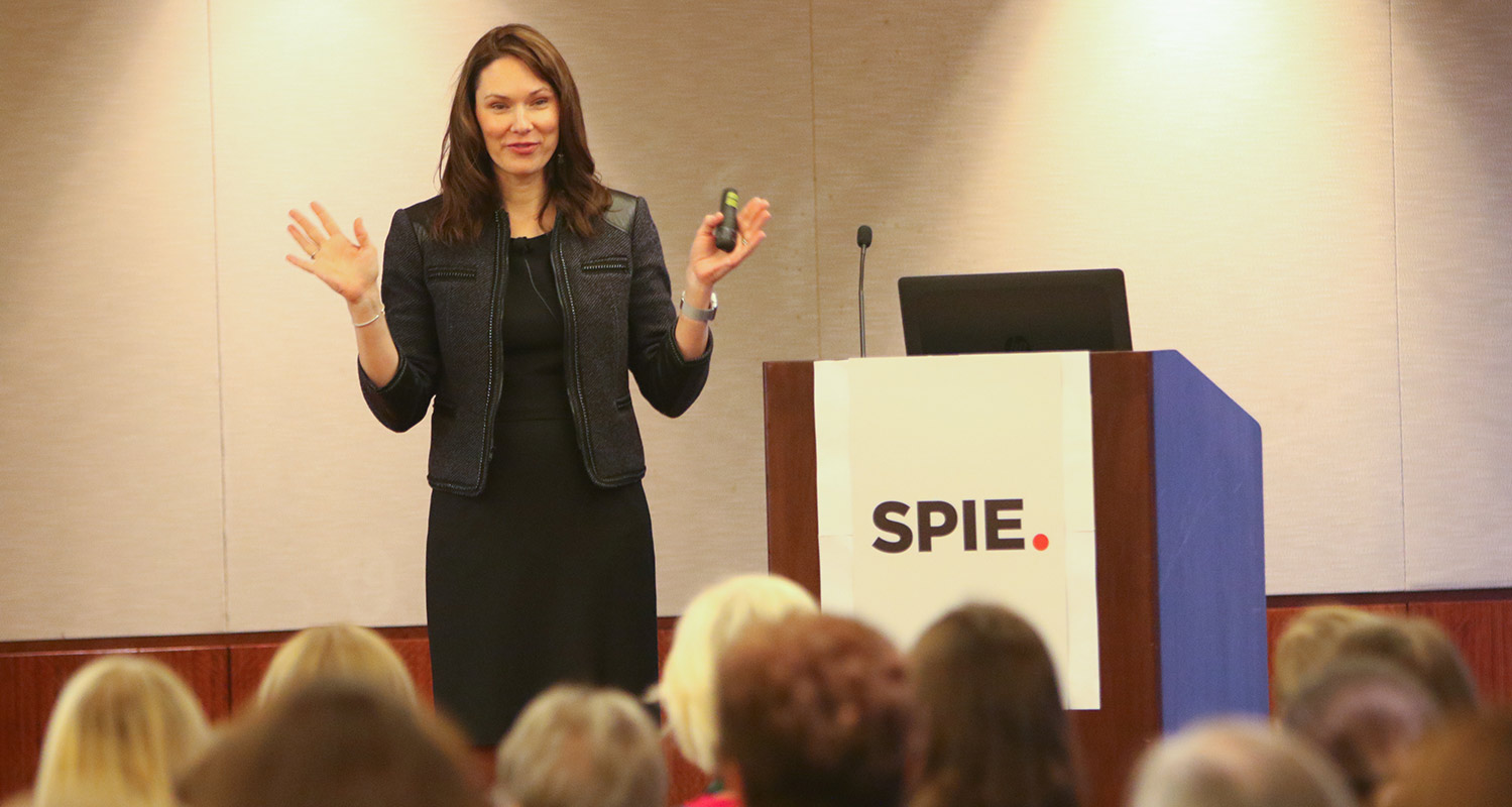 Alexis Vogt standing in front of a classroom at an SPIE event