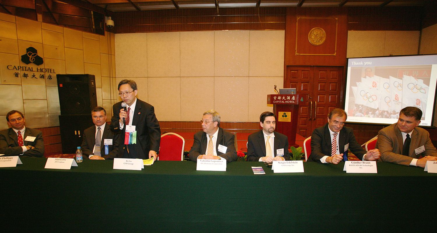 Bo Gu sitting at a table with others for a panel discussion