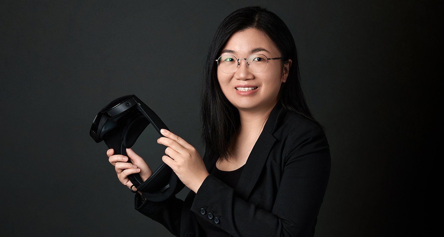 Fenglin Peng holding a headset for AR-MR-VR