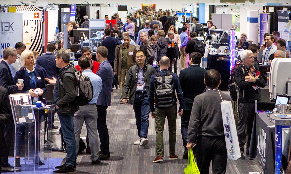 A crowded exhibition floor at an SPIE event