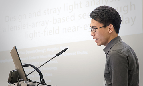 An author presenting research at Optical Systems Design 
