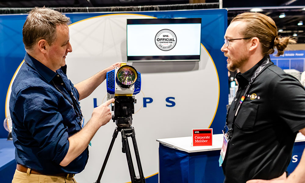 Two men discuss technology at an SPIE exhibition properly set up with official contractors