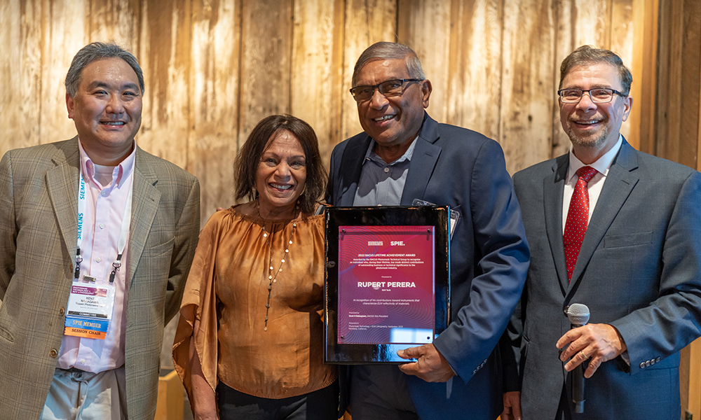 BACUS scholarship winner stands with award and BACUS chairs