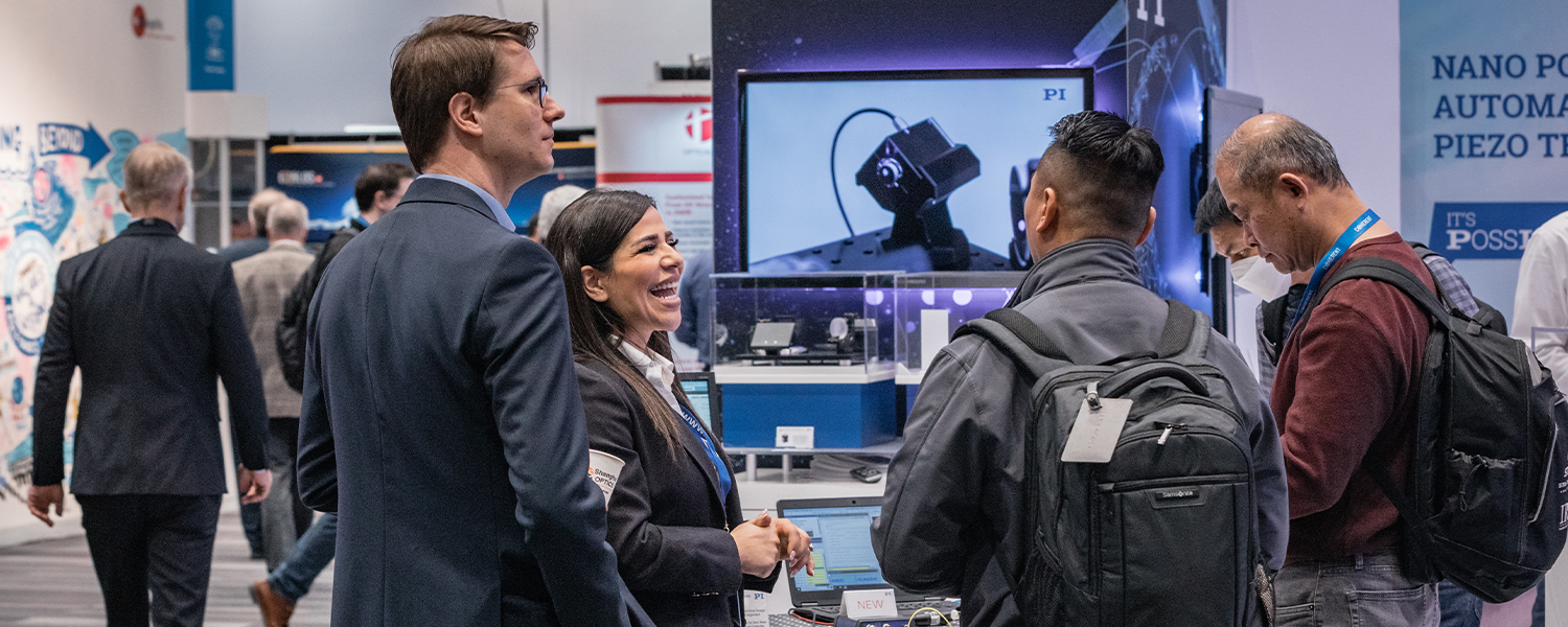 Exhibitors converse with attendees at SPIE Photonics West Exhibition