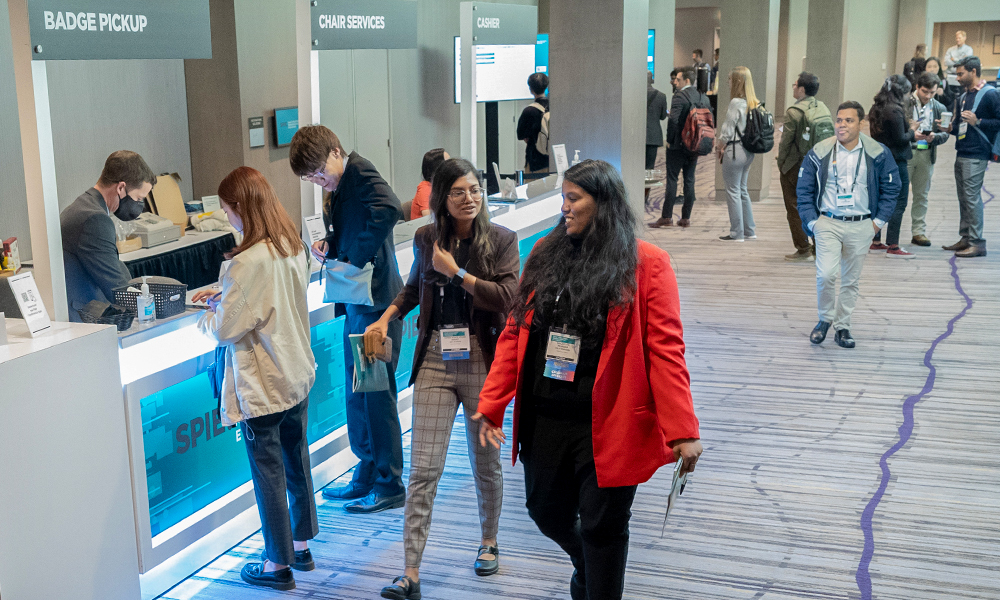 Attendees stop by registration desk