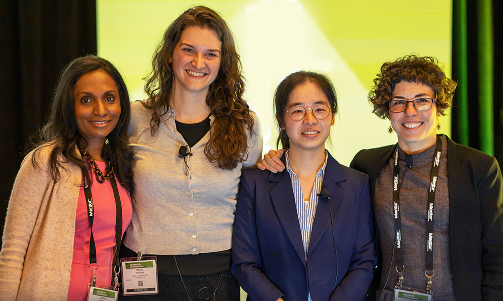 Four professional women stand together at SPIE Photonics West