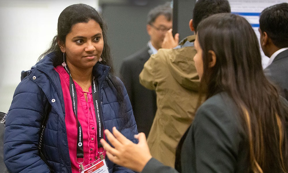 Two women attendees connect at an SPIE conference