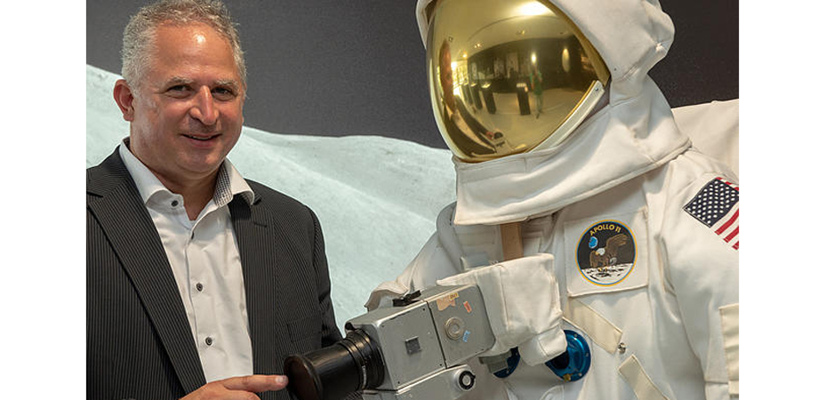 Vladan Blahnik stands next to a space suit in the ZEISS Museum