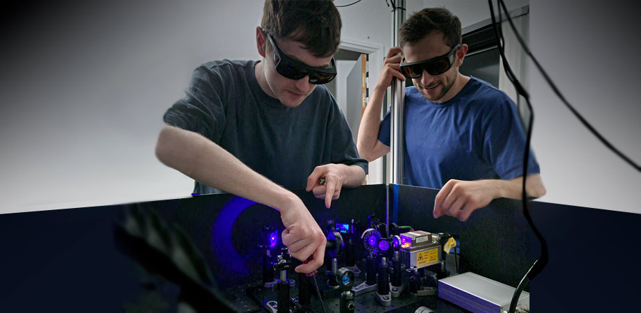 Patrick Cameron, left, with intern Remy Grasland, aligning a new photon-pair source that will test new cameras. 