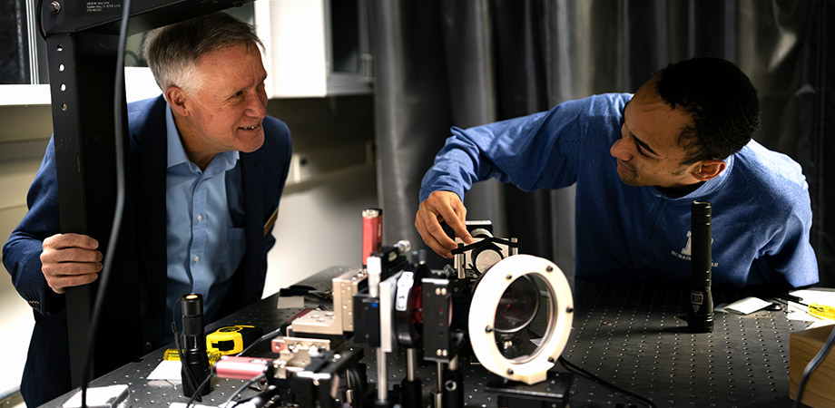 2025 SPIE G.G. Stokes Award recipient Thomas Brown, left, with Demetrious Dowdell, a PhD student at the Institute of Optics. The experiment they are working on encompasses holographic shearing interferometry, configured for testing freeform surfaces.  