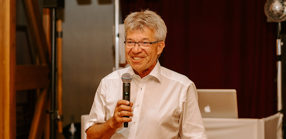 Wilhelm Ulrich speaking into a microphone.